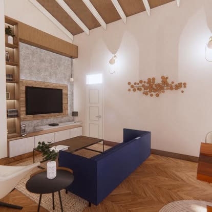 The same living room seen from the entry, showing the herringbone floor and a copper disc wall sculpture